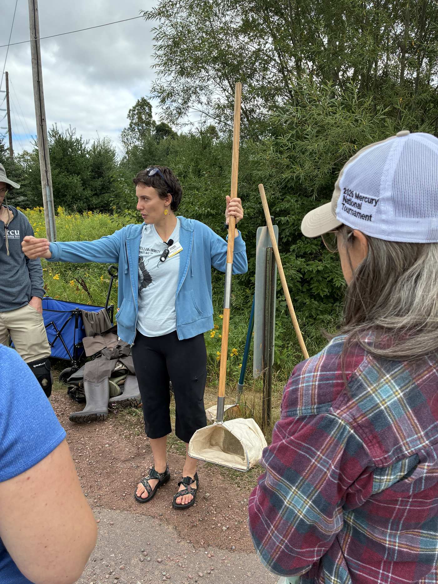 Emma demonstrating macroinvertebrate sampling technique with a D-net in Whittlesey Creek
