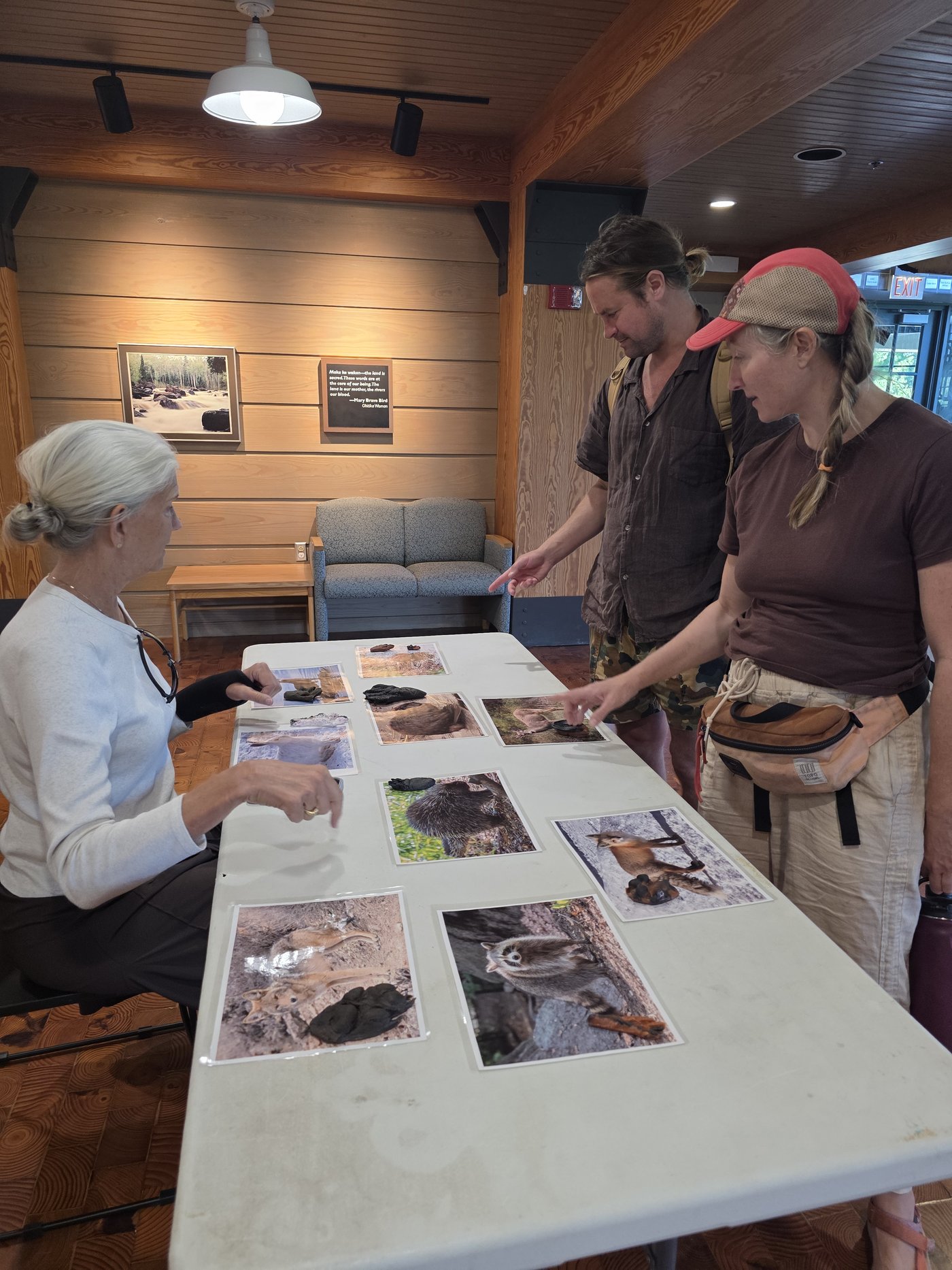 Discussing animal tracks and scat identification with visitors at the Northern Great Lakes Visitor Center