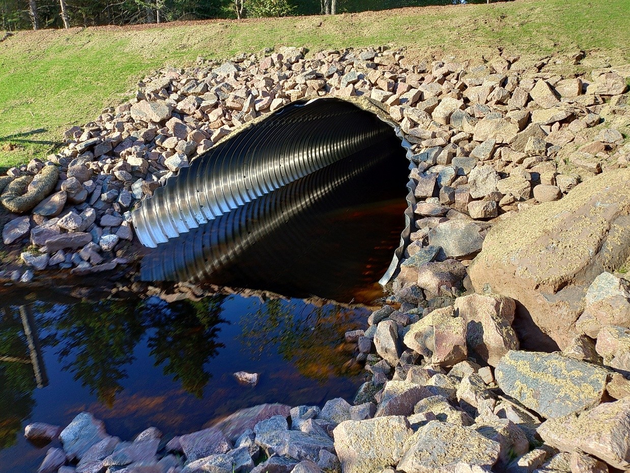 Stream simulation culvert allowing natural water flow and aquatic organism passage at Happy Creek