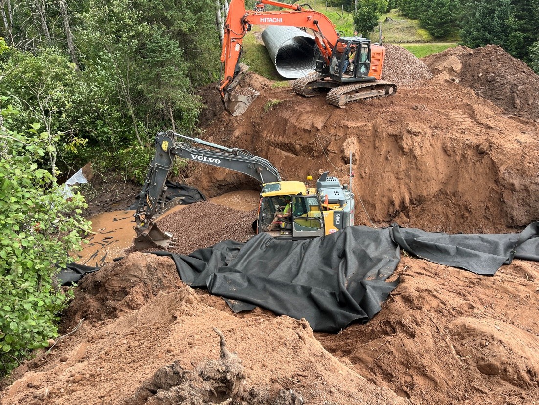 Ashland County dump truck and excavator during culvert construction