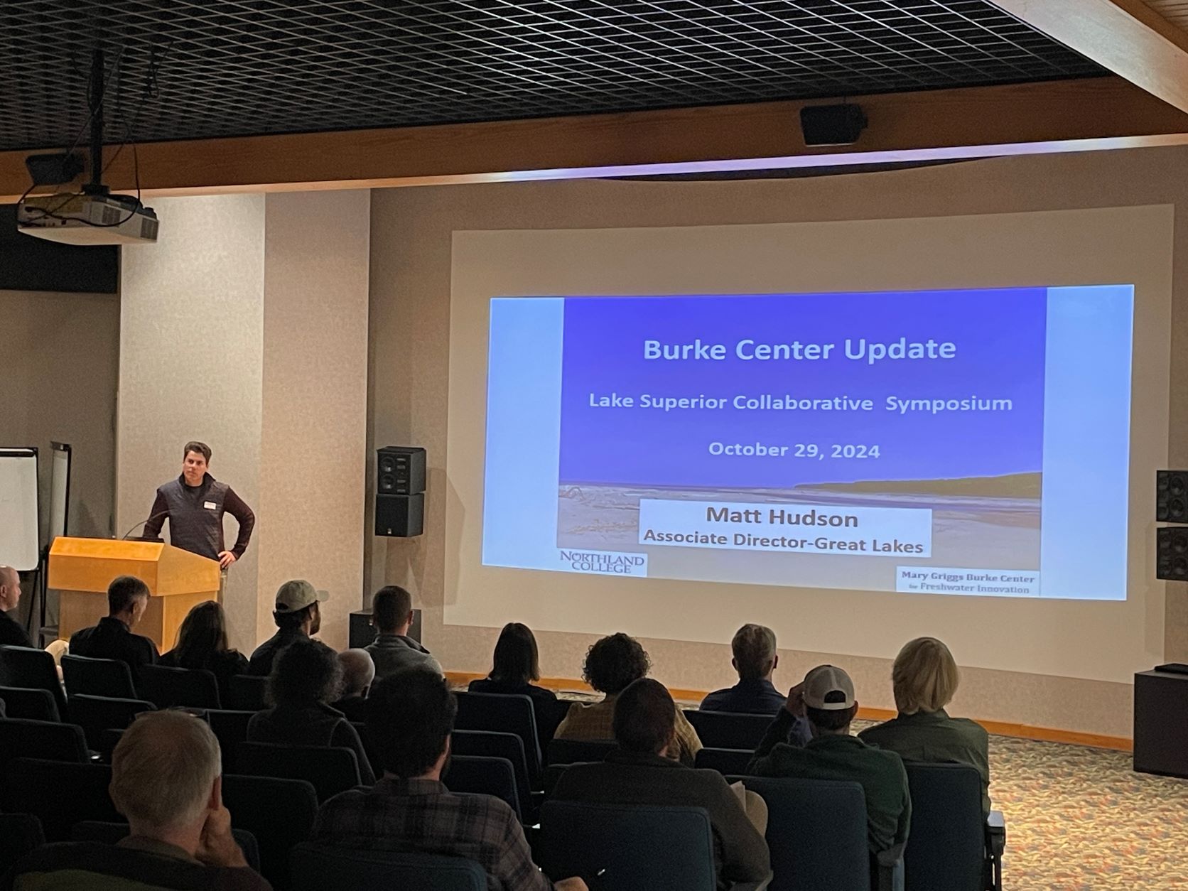 Matt Hudson of the Burke Center for Ecosystem Research presenting a lightning talk at the 2024 LSC Symposium at the Northern Great Lakes Visitor Center