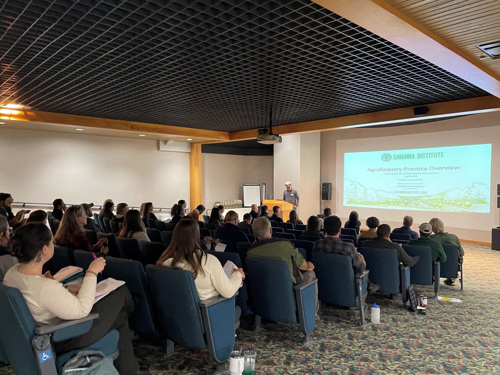 Attendees listening to a Savanna Institute agroforestry presentation during lightning talks at the 2024 LSC Symposium