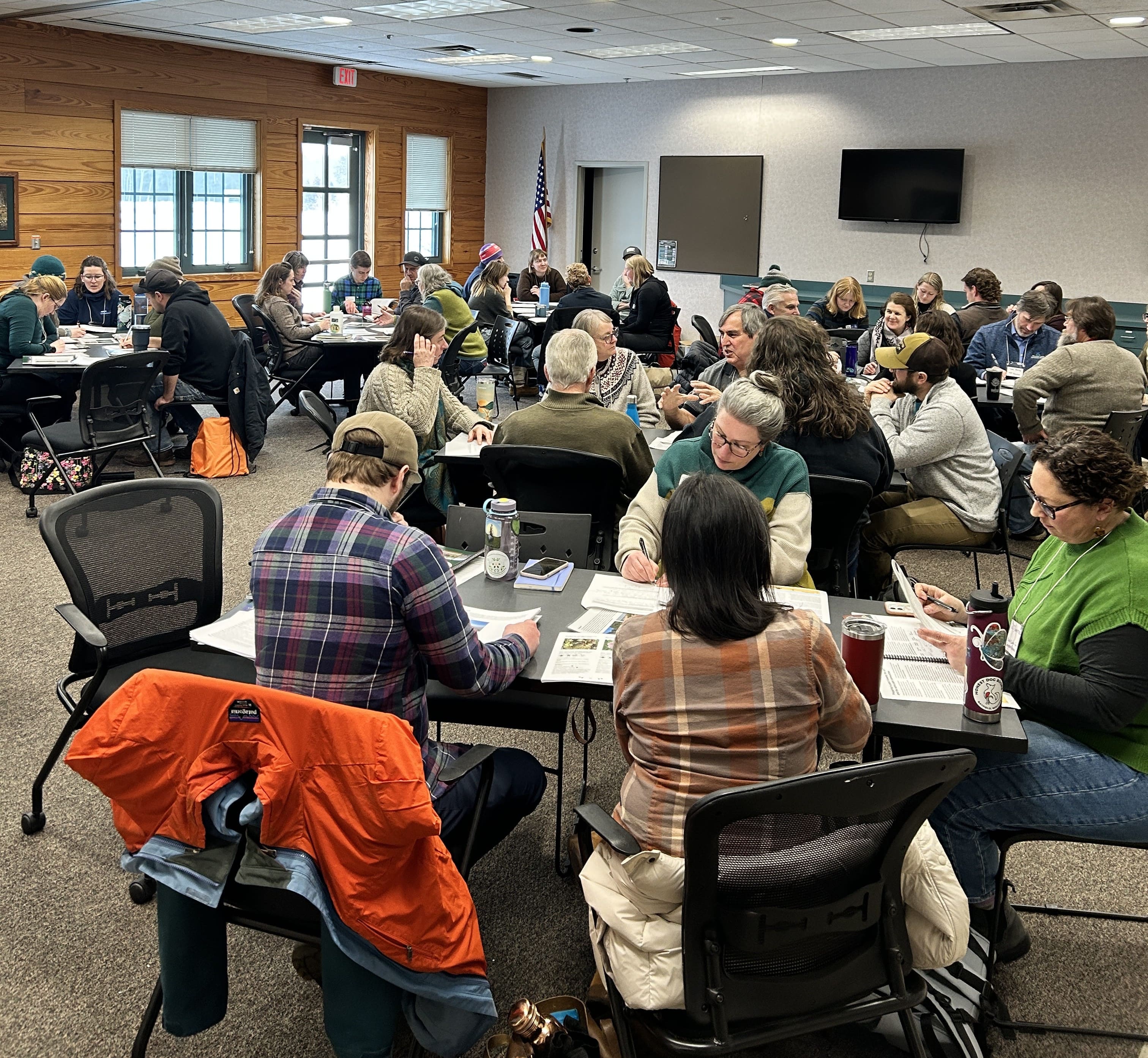 Participants seated at tables during a 2026 LSC Symposium workshop session at the Northern Great Lakes Visitor Center