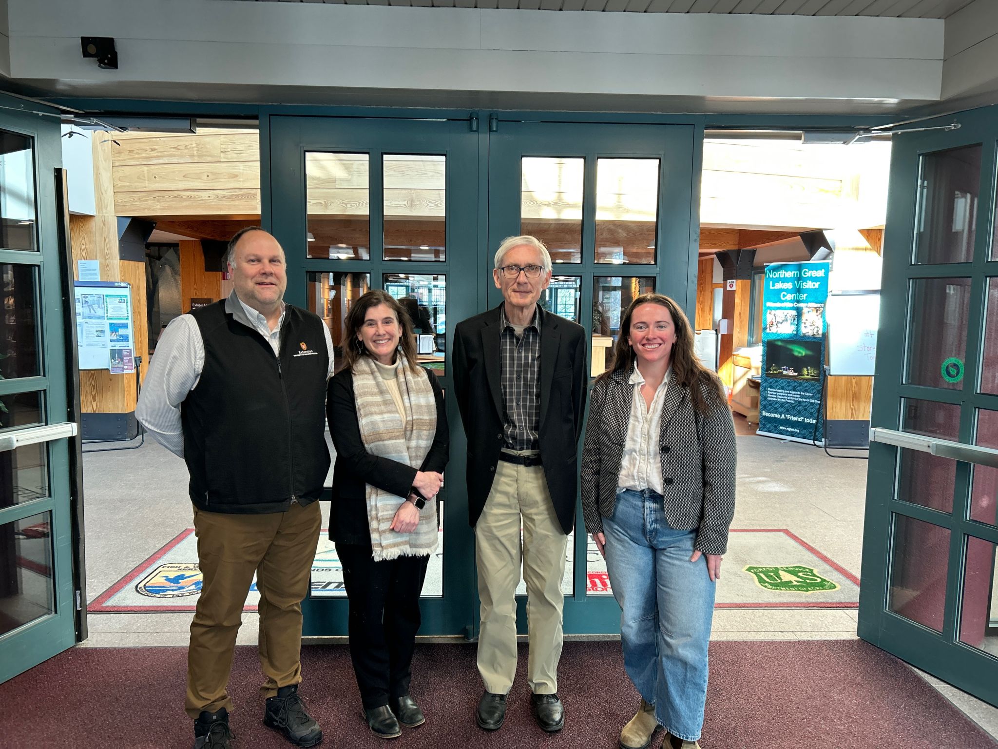 Governor Tony Evers with UW–Madison Extension staff at the Northern Great Lakes Visitor Center during the 2026 LSC Symposium